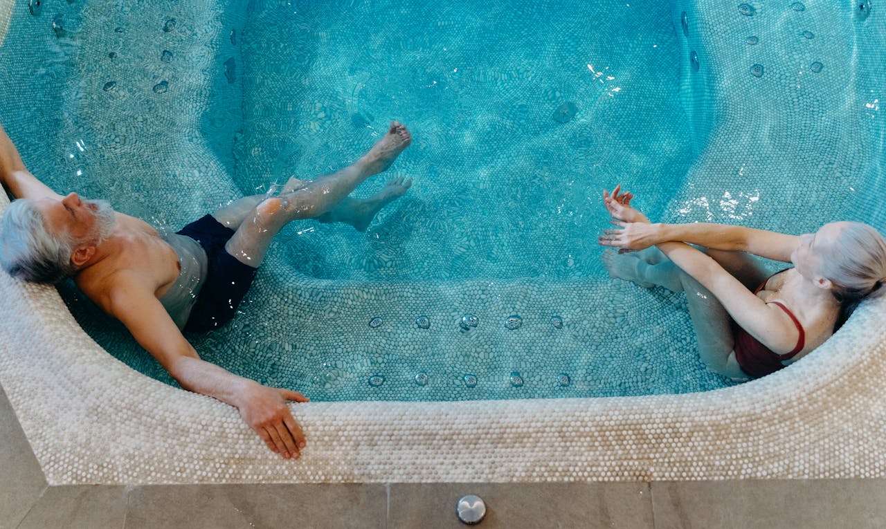 aerial view of two people sitting in a spa vs hot tub