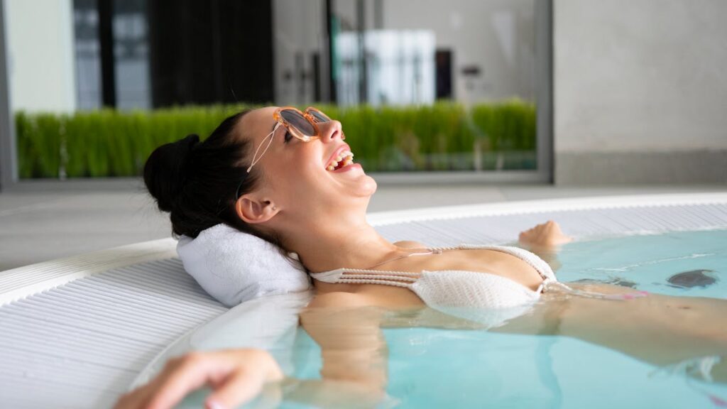 woman smiling in a hot tub, spa, spa vs hot tub